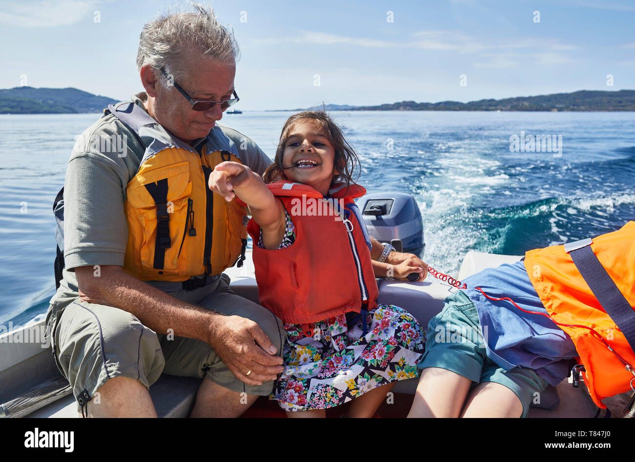 Grandfather and grandchildren on boat ride Stock Photo