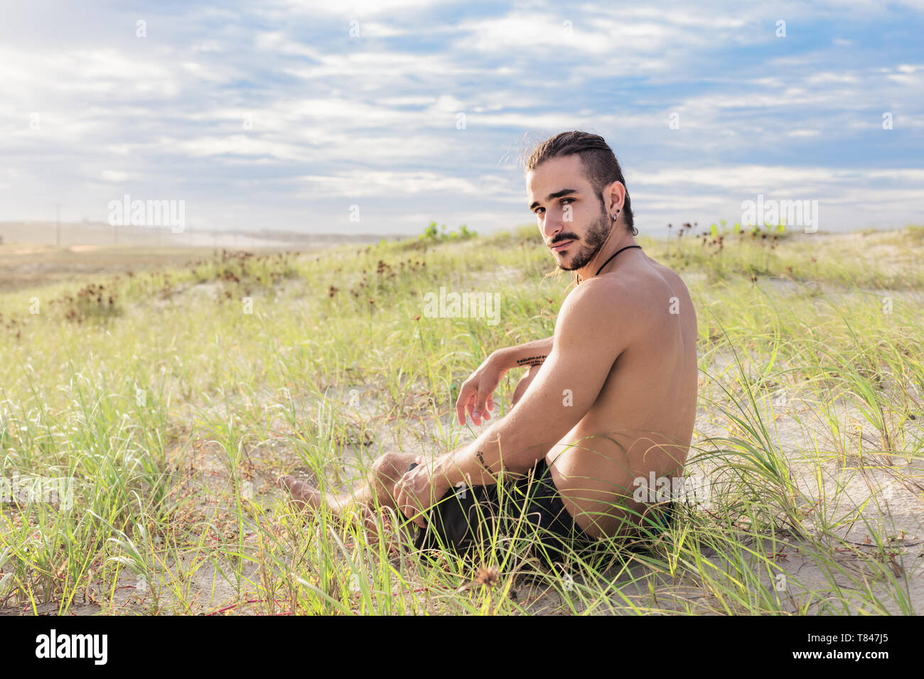 Man relaxing on field, Fortaleza, Ceara, Brazil Stock Photo