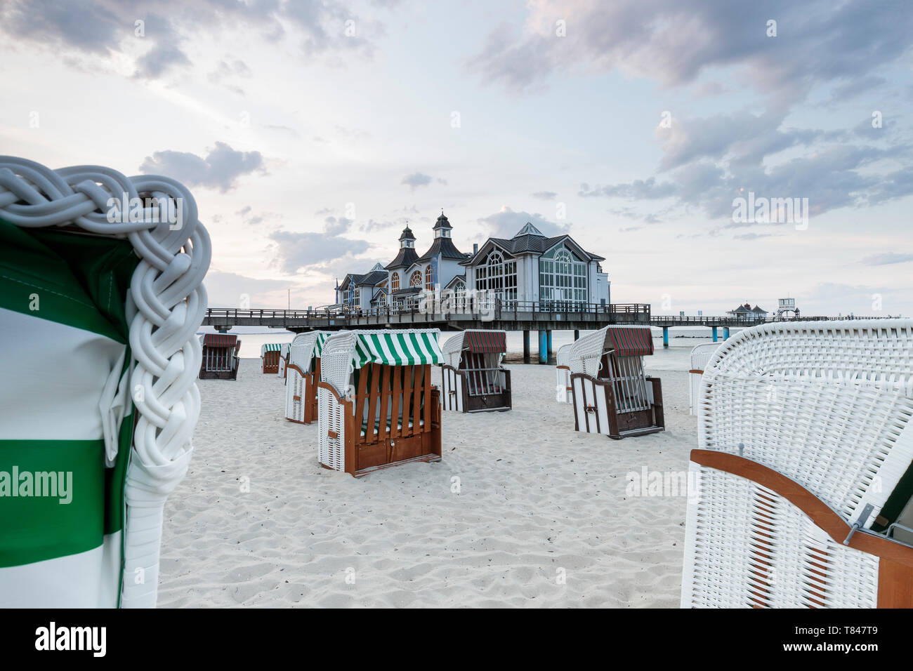 Traditional beach chairs and pier, Sellin, Rugen, Mecklenburg-Vorpommern, Germany Stock Photo