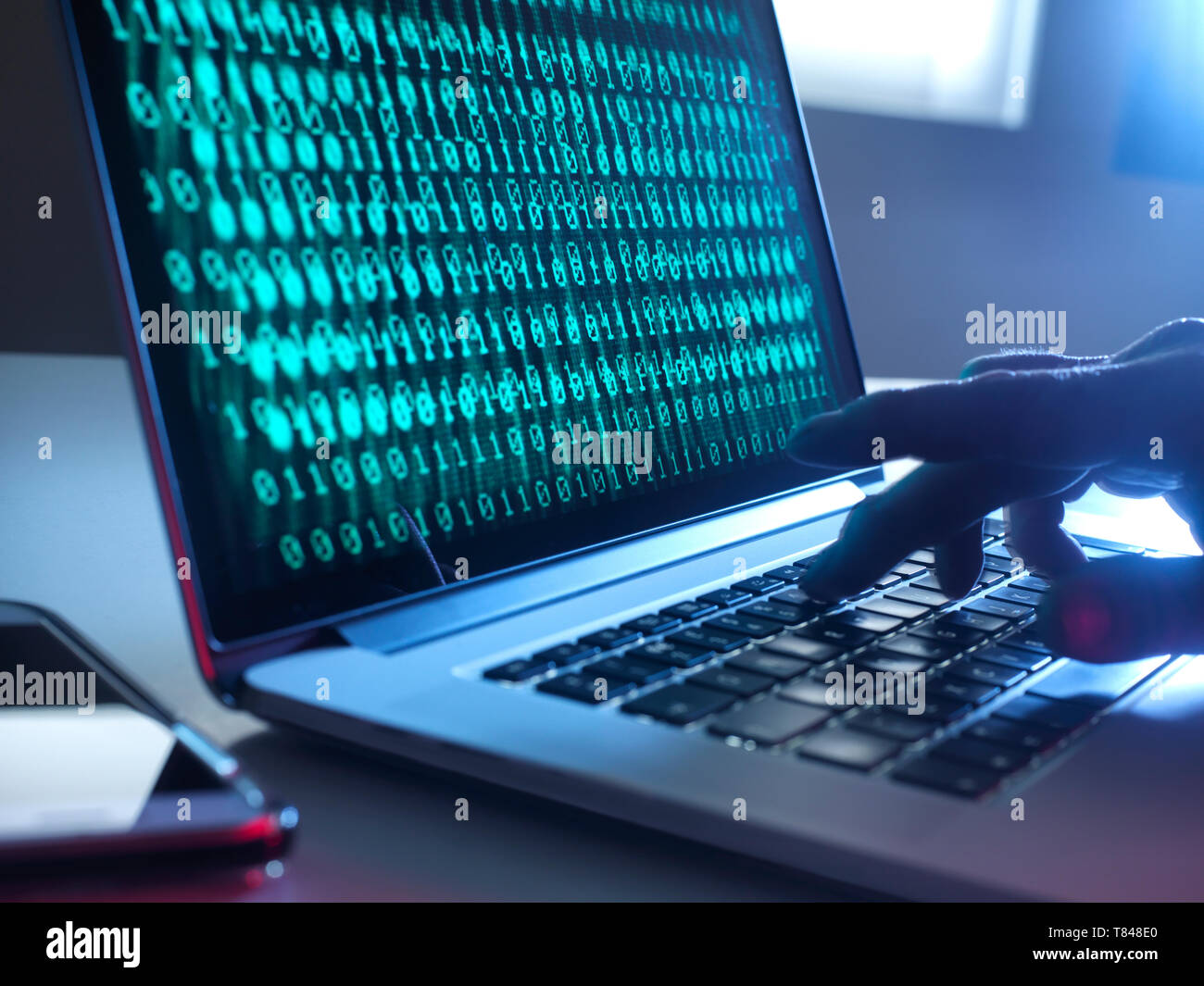 Cyber Crime, laptop computer being hacked Stock Photo