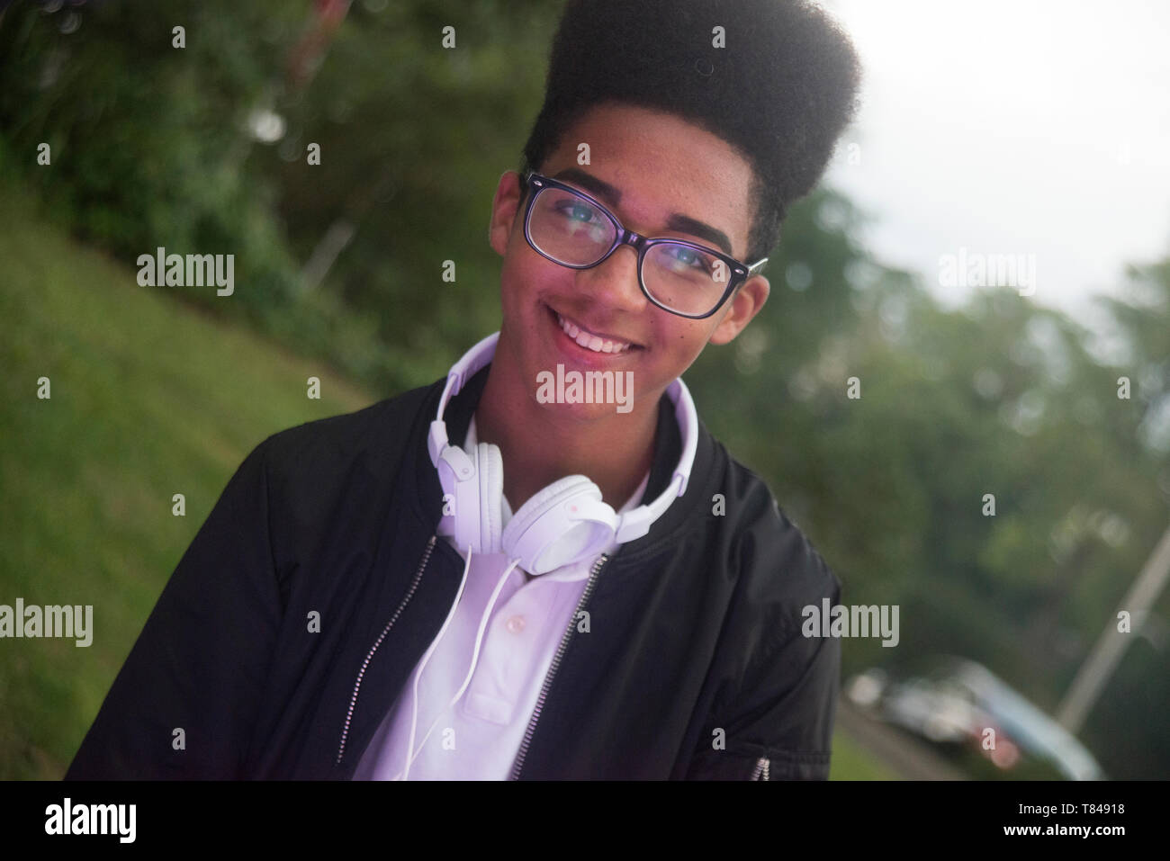 Teenage boy with afro flat top hairstyle in park , portrait Stock Photo