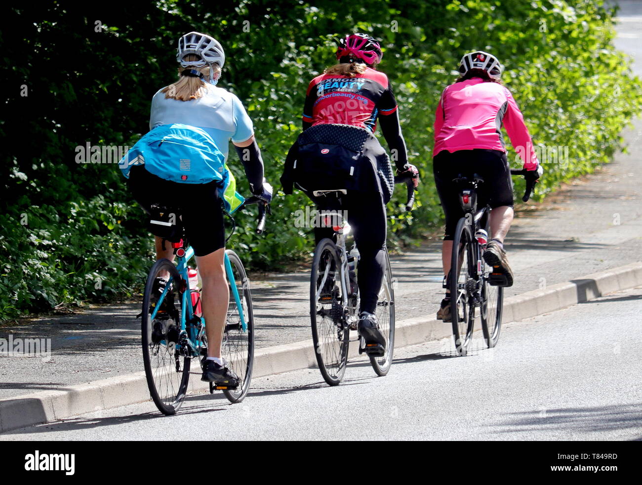 Cyclist Trio on Devon Road, South Hams, Ivybridge, SW England Stock Photo