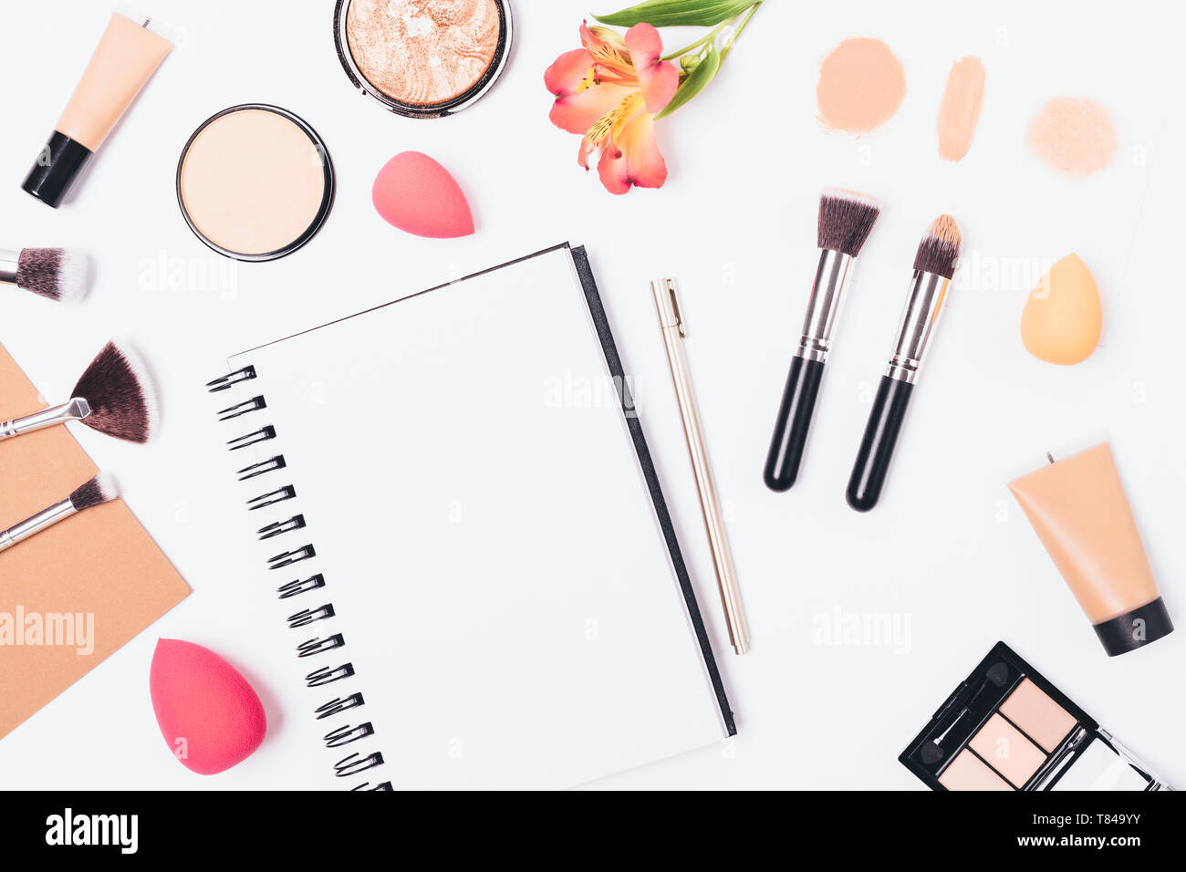 Makeup Theme Notepad Empty notepad with pen among cosmetics and accessories on white ...