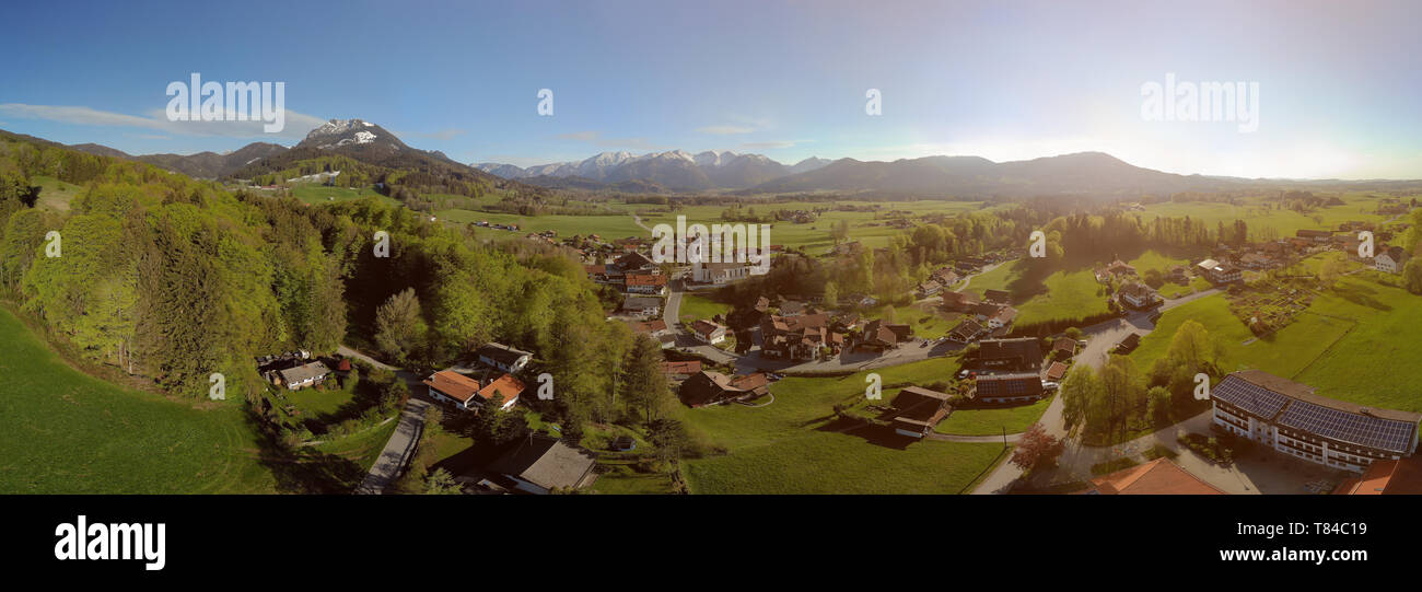 Panoramic view of Bavarian village in beautiful landscape with alps and blue sky Stock Photo