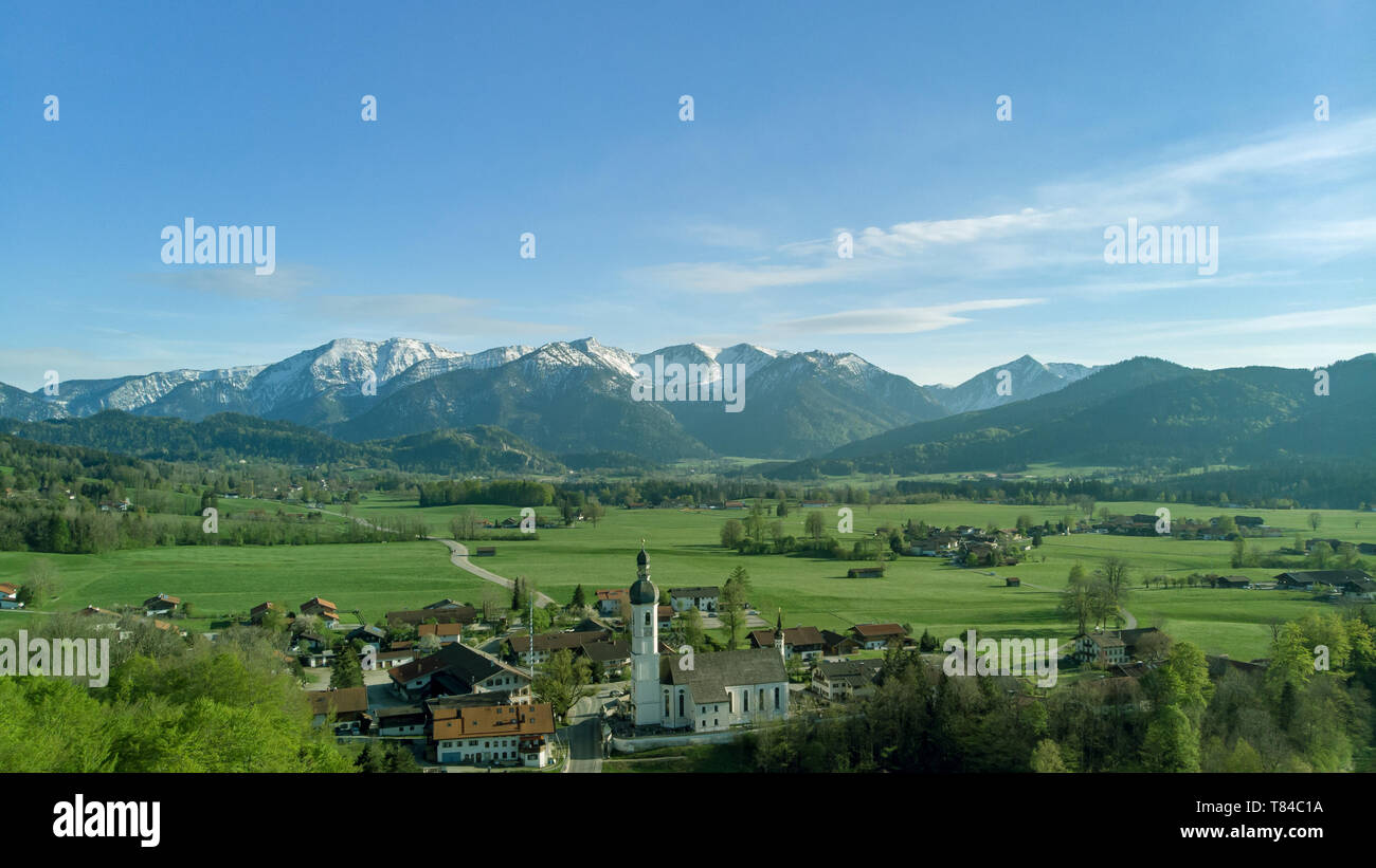 Panoramic view of Bavarian village in beautiful landscape with alps and blue sky Stock Photo