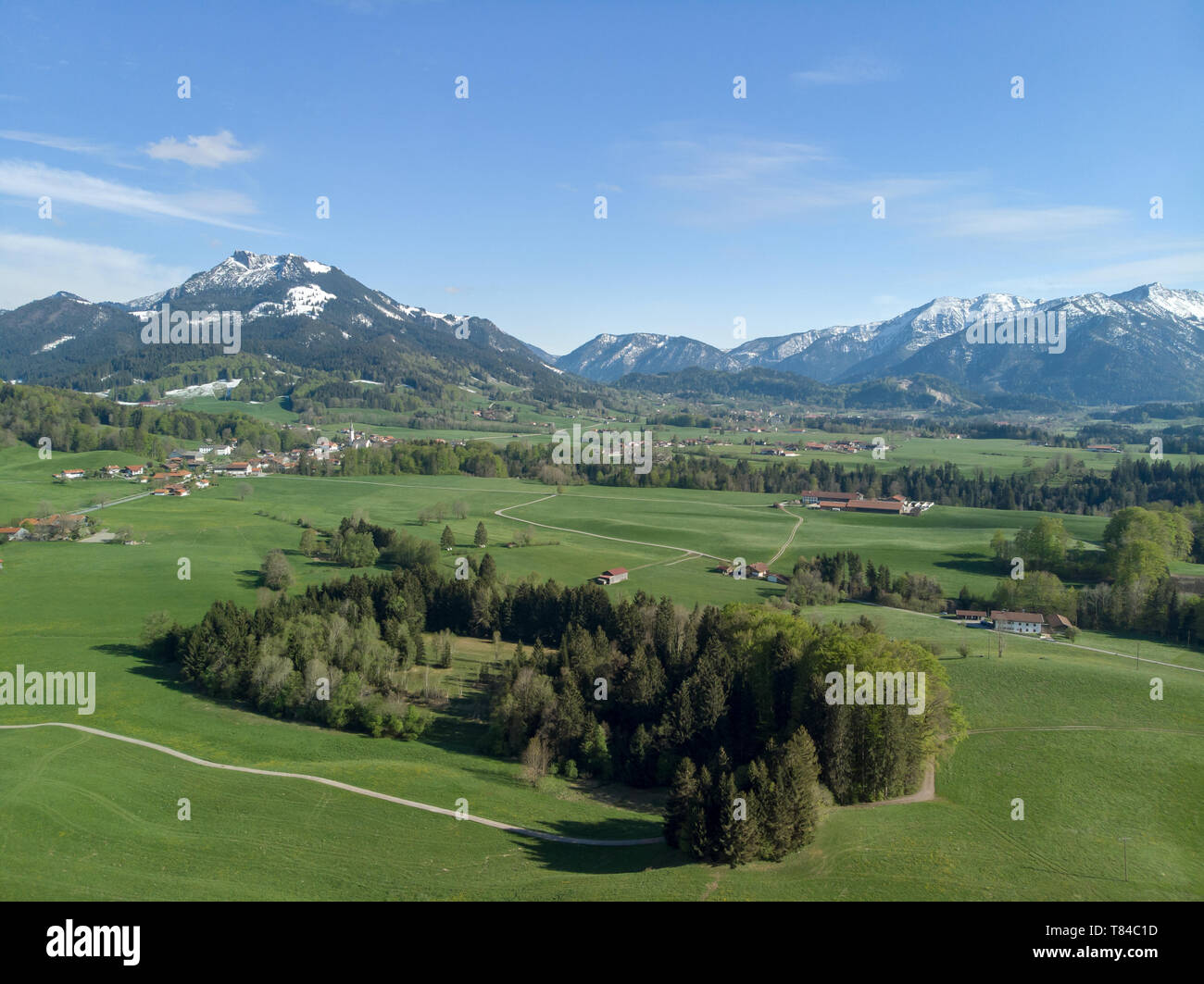 Aerial view of typical Bavarian landscape with background alps and blue sky Stock Photo