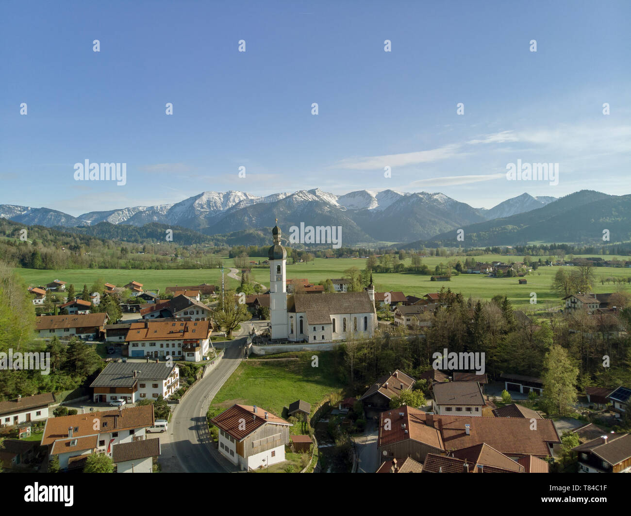 Aerial view of Bavarian village in beautiful landscape with alps and blue sky Stock Photo