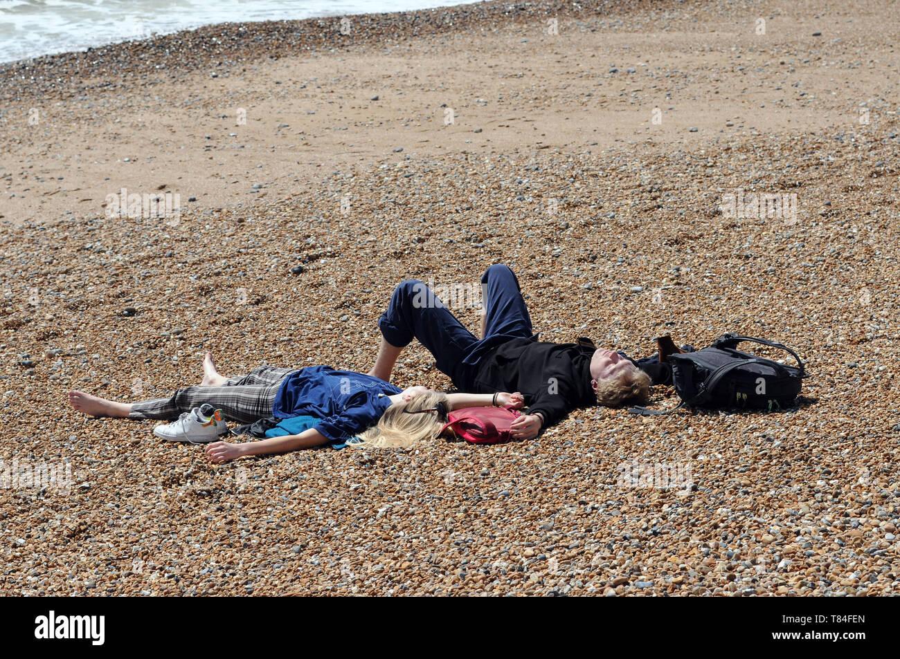 Brighton, UK. 10th May 2019. People enjoy the Friday sunshine on Brighton Beach after the weather improves after a cold bank holiday. Credit: JOHNNY ARMSTEAD/Alamy Live News Stock Photo