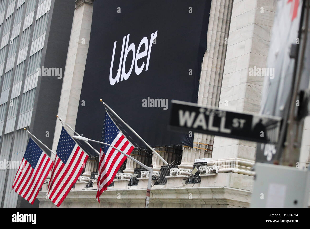 New York, USA. 10th May, 2019. A banner of Uber Technologies Inc. is seen hanging outside the New York Stock Exchange in New York, the United States, May 10, 2019. U.S. ride hailing company Uber Technologies Inc. began trading on the NYSE on Friday. Credit: Wang Ying/Xinhua/Alamy Live News Stock Photo