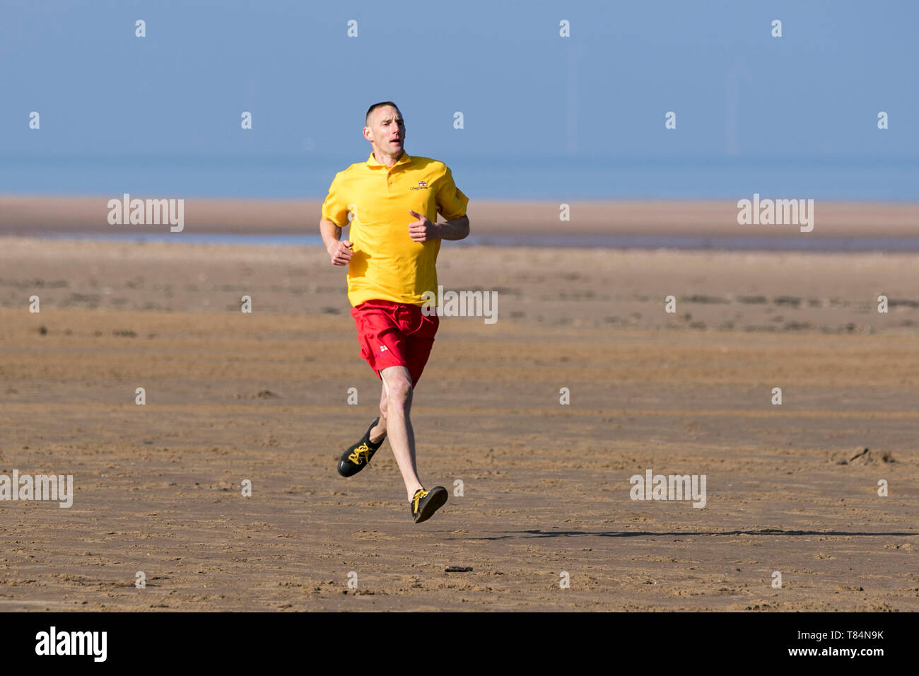 Southport, Merseyside, UK. 11th May 2019. RNLI Lifeguard Training.  An RNLI lifeguard trainee is put through his paces as he aspires to reach the level of fitness required to protect beachgoers during the upcoming summer season.  RNLI lifeguards and lifeboat crews work together, responding to the thousands of incidents that happen every year around the coast.  Credit: Cernan Elias/Alamy Live News Stock Photo