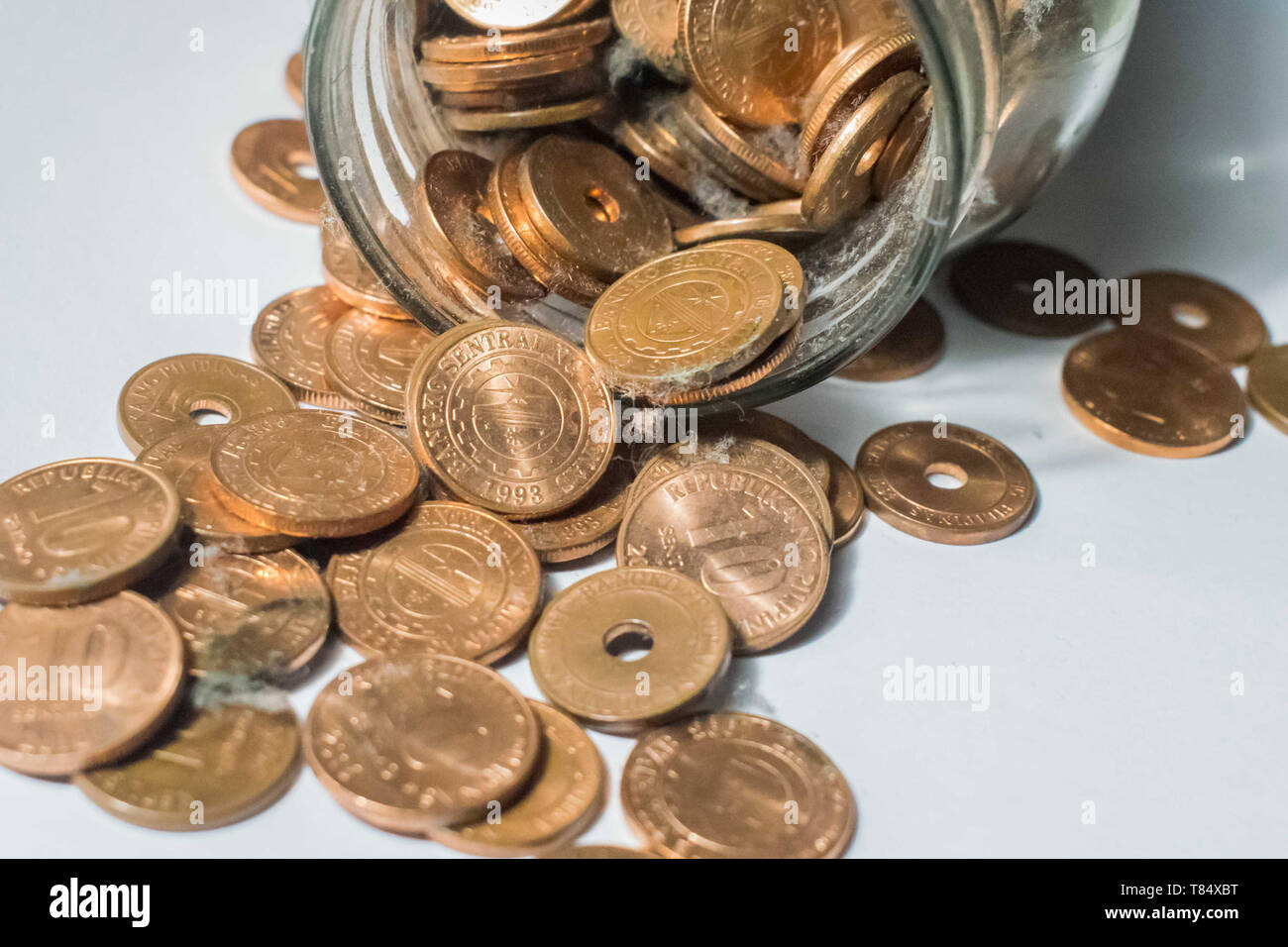Glass jar full of coins, money savings concept Stock Photo