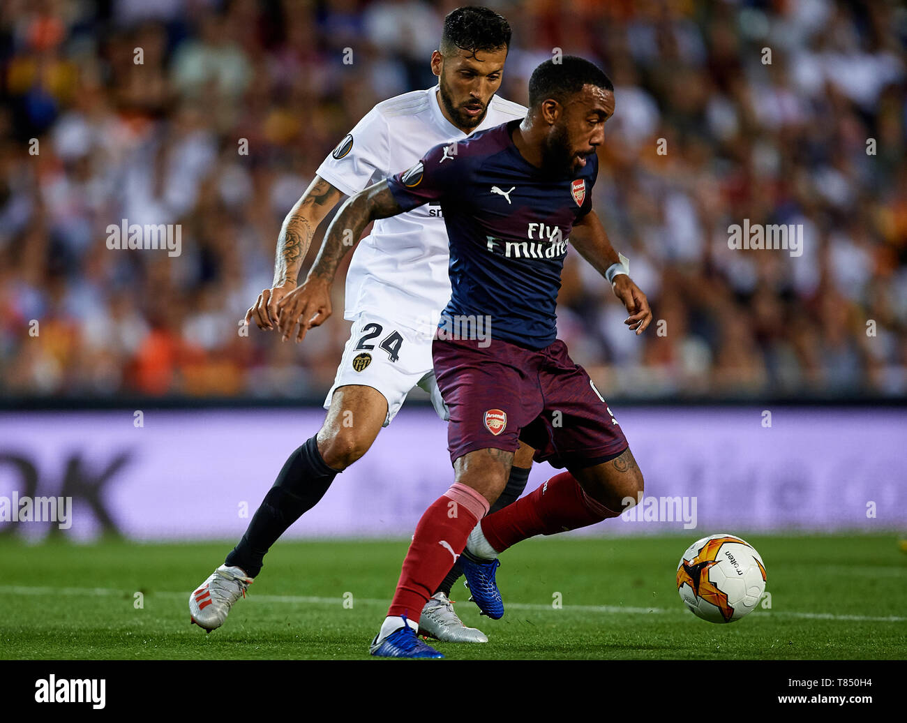 VALENCIA, SPAIN - MAY 09: Alexandre Lacazette (R) of Arsenal competes for the ball with Ezequiel Garay of Valencia CF during the UEFA Europa League Semi Final Second Leg match between Valencia and Arsenal at Estadio Mestalla on May 9, 2019 in Valencia, Spain. (Photo by David Aliaga/MB Media) Stock Photo