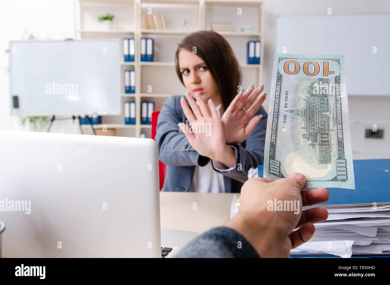 Beautiful female employee unhappy with excessive work Stock Photo
