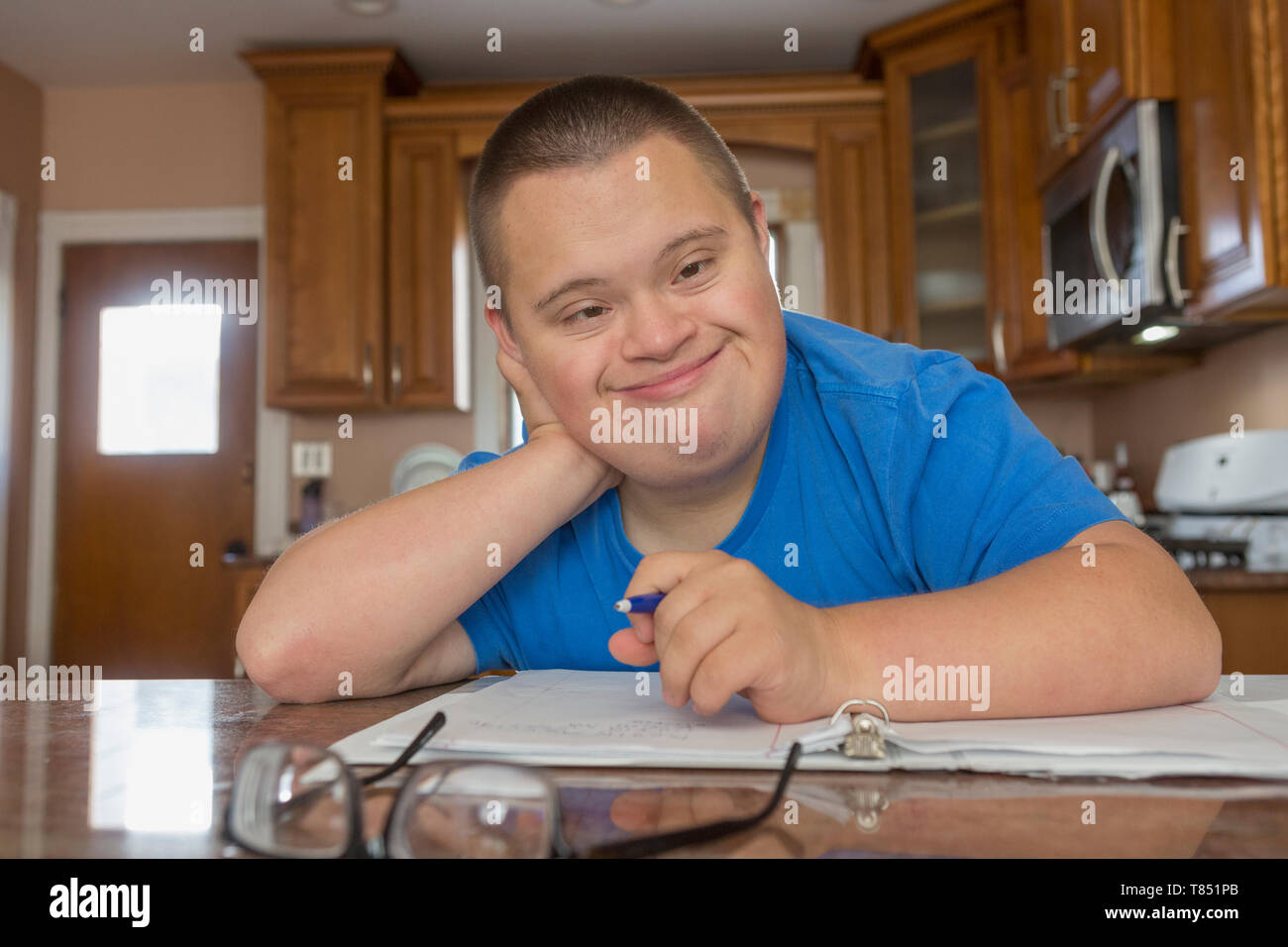 Teen with Down Syndrome studying Stock Photo