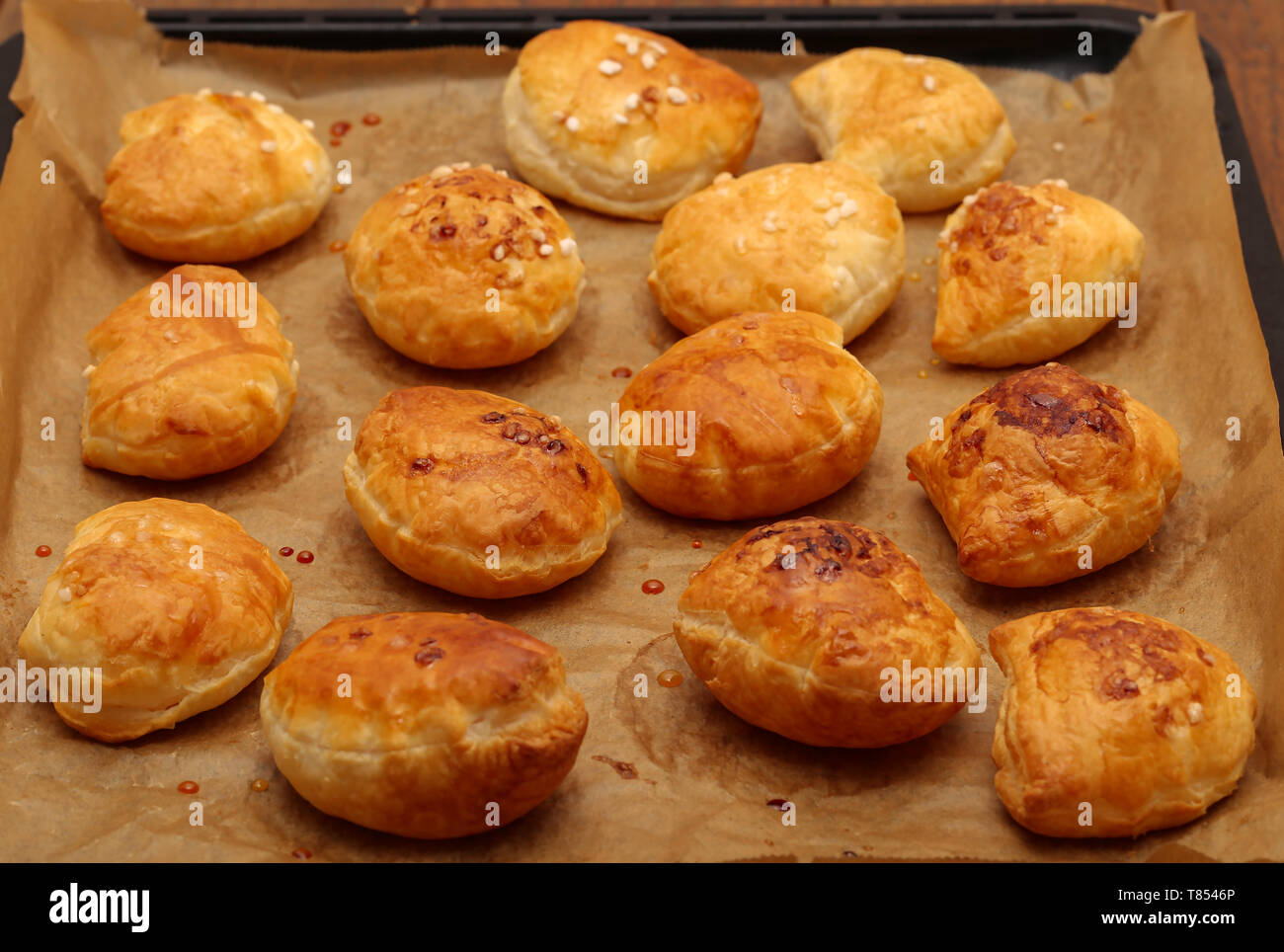 Freshly baked ruddy buns cool on the table. Stock Photo