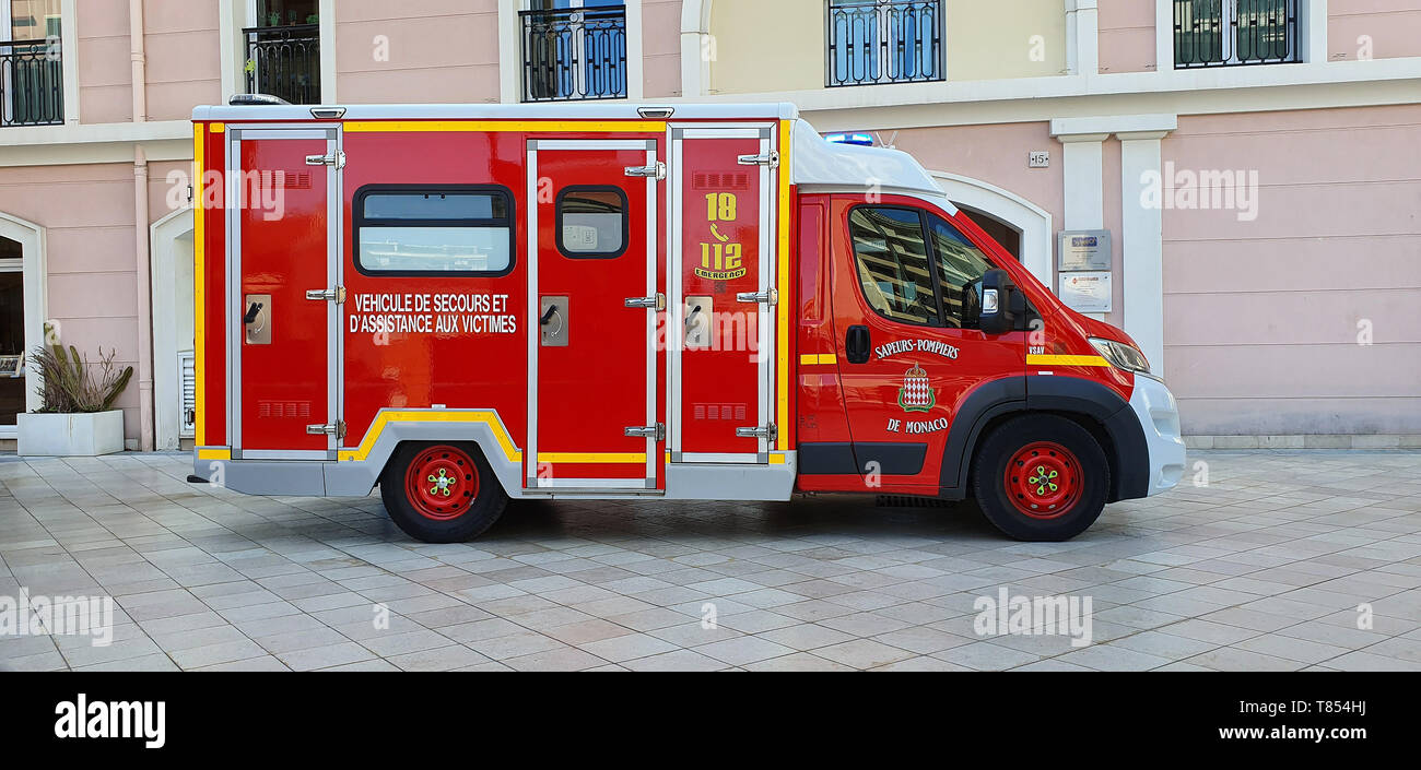 Monte-Carlo, Monaco - March 28,  French Red And White Fire Department Ambulance Van (Side View) Parked In The Street Of Monaco, With Lights, French Ri Stock Photo