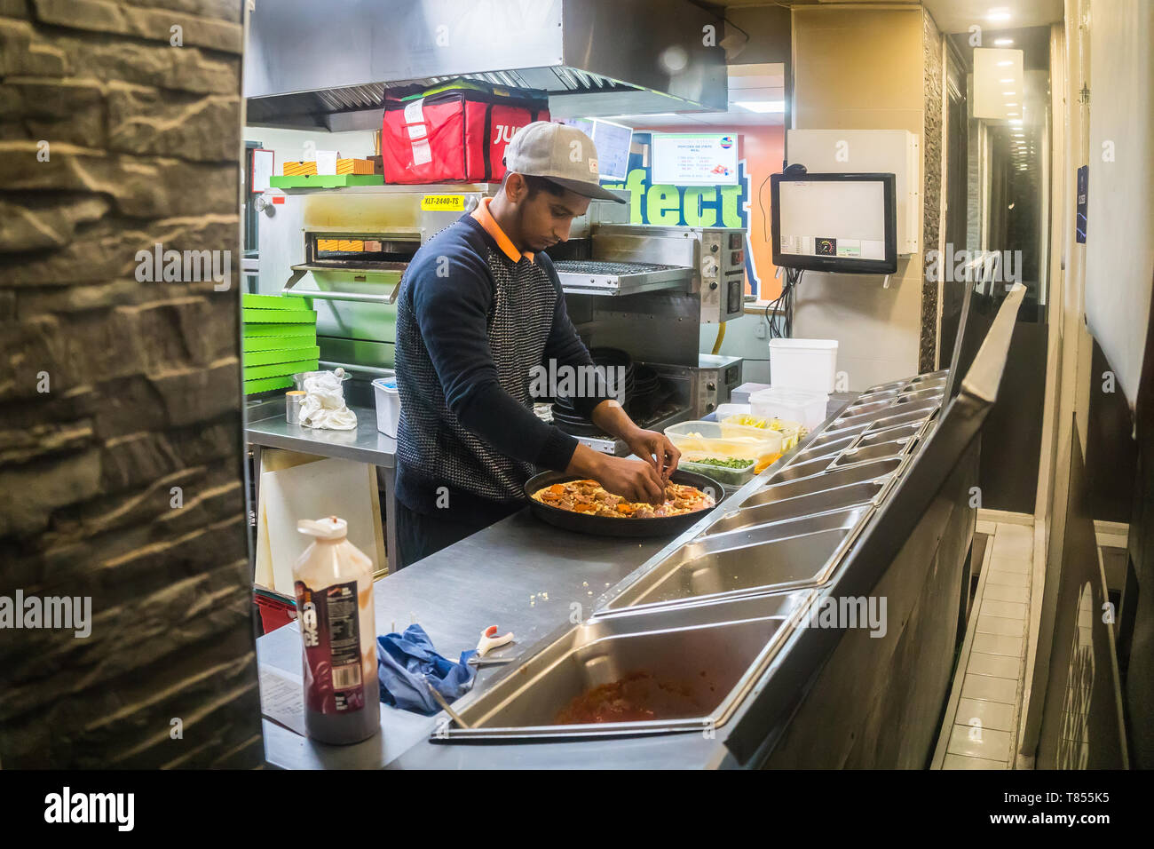 Stevenage, UK - January 24, 2019 - a cook at a restaurant kitchen Stock Photo