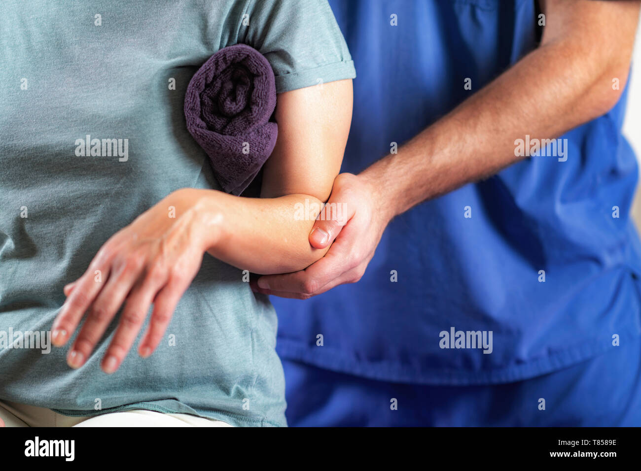 Physical therapist examining patient's arm Stock Photo Alamy