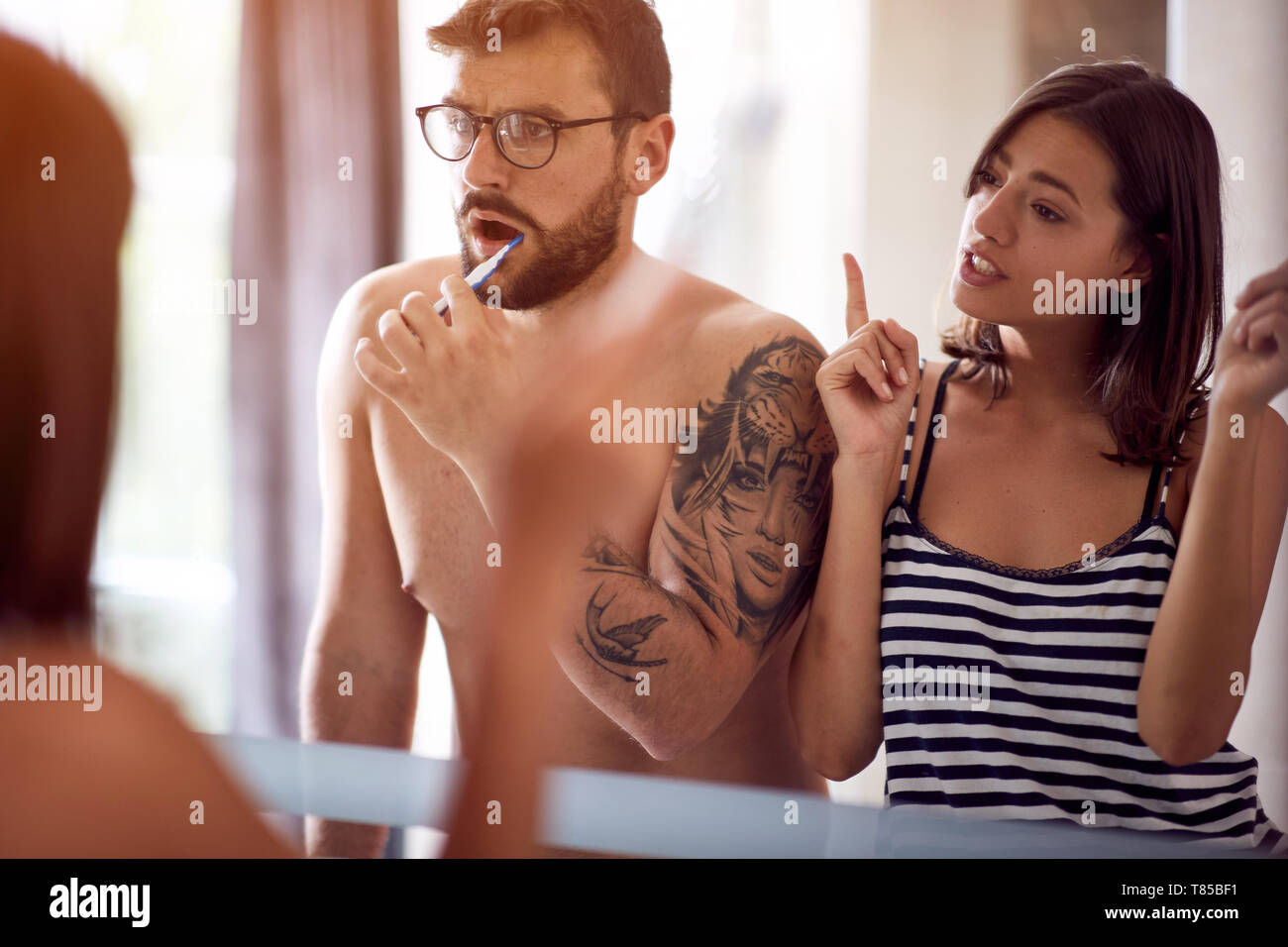 attractive young couple brushing their teeth. Stock Photo