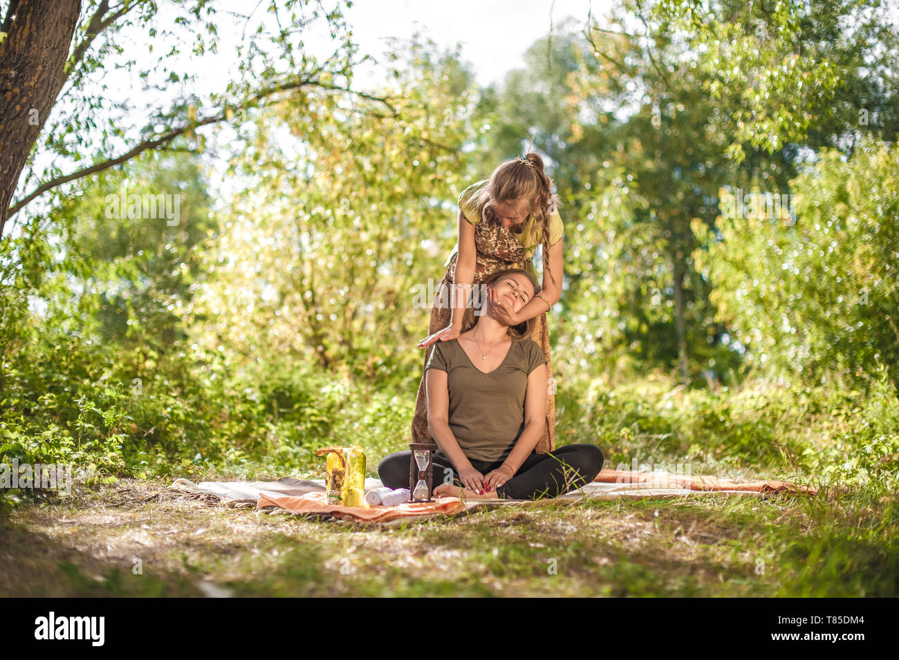 Master massage therapist thuroughly massages a girl in nature Stock Photo -  Alamy