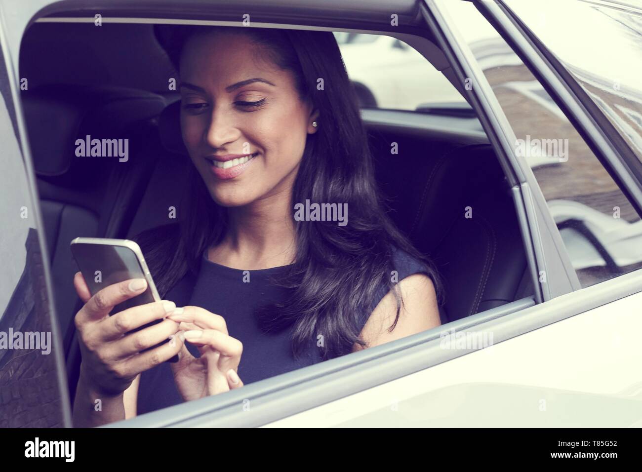 Business woman sitting in car Stock Photo