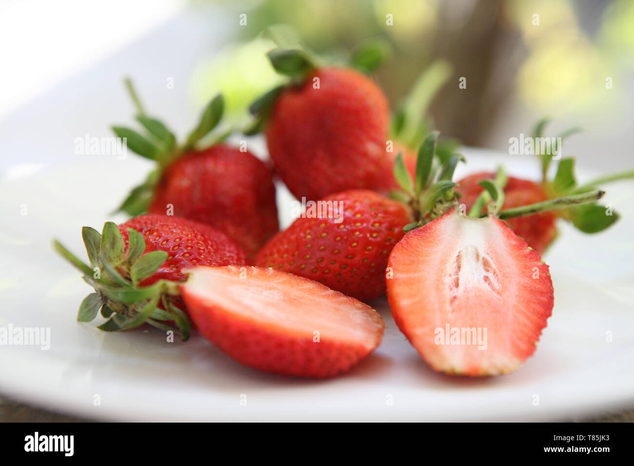 One strawberry and half cut out hi-res stock photography and images - Alamy