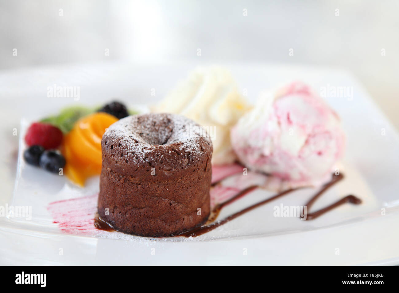 Chocolate Lava Cake with ice cream and fruit Stock Photo Alamy