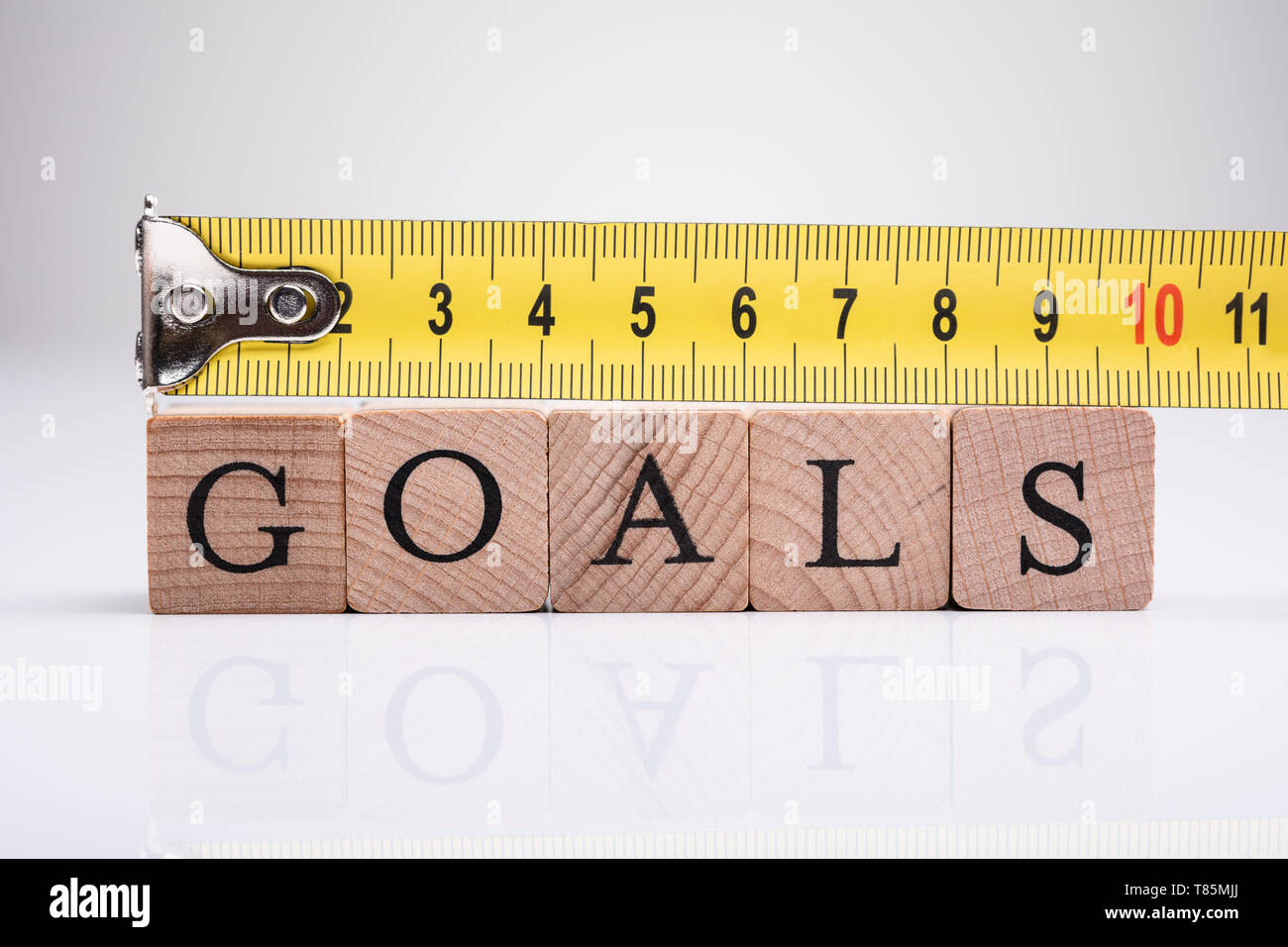 Yellow Measuring Tape Over The Wooden Goals Blocks Stock Photo Alamy