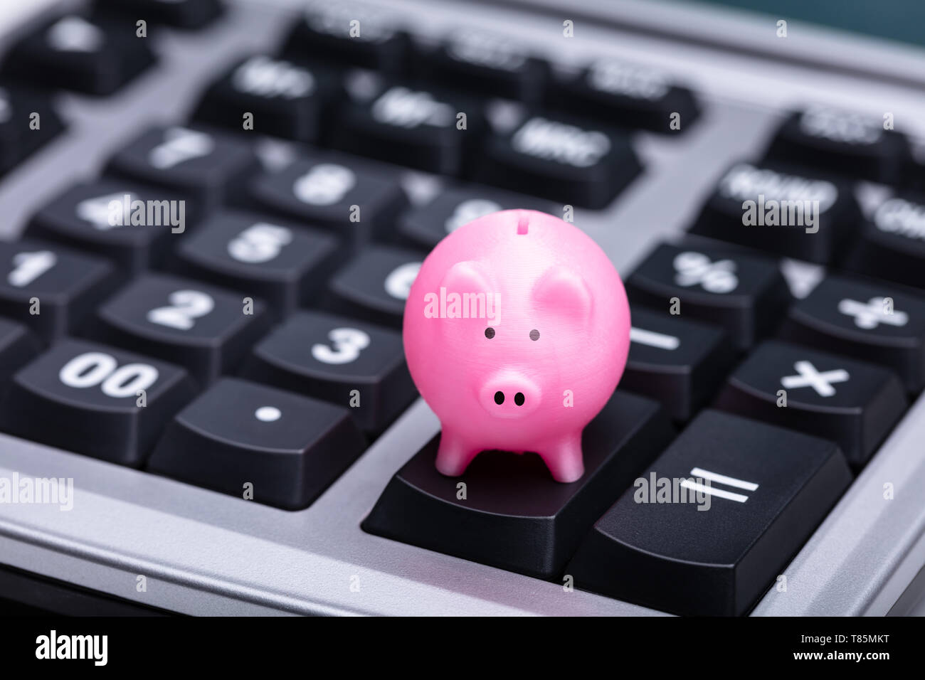 Close-up Of Small Pink Piggy Bank On Calculator Stock Photo - Alamy