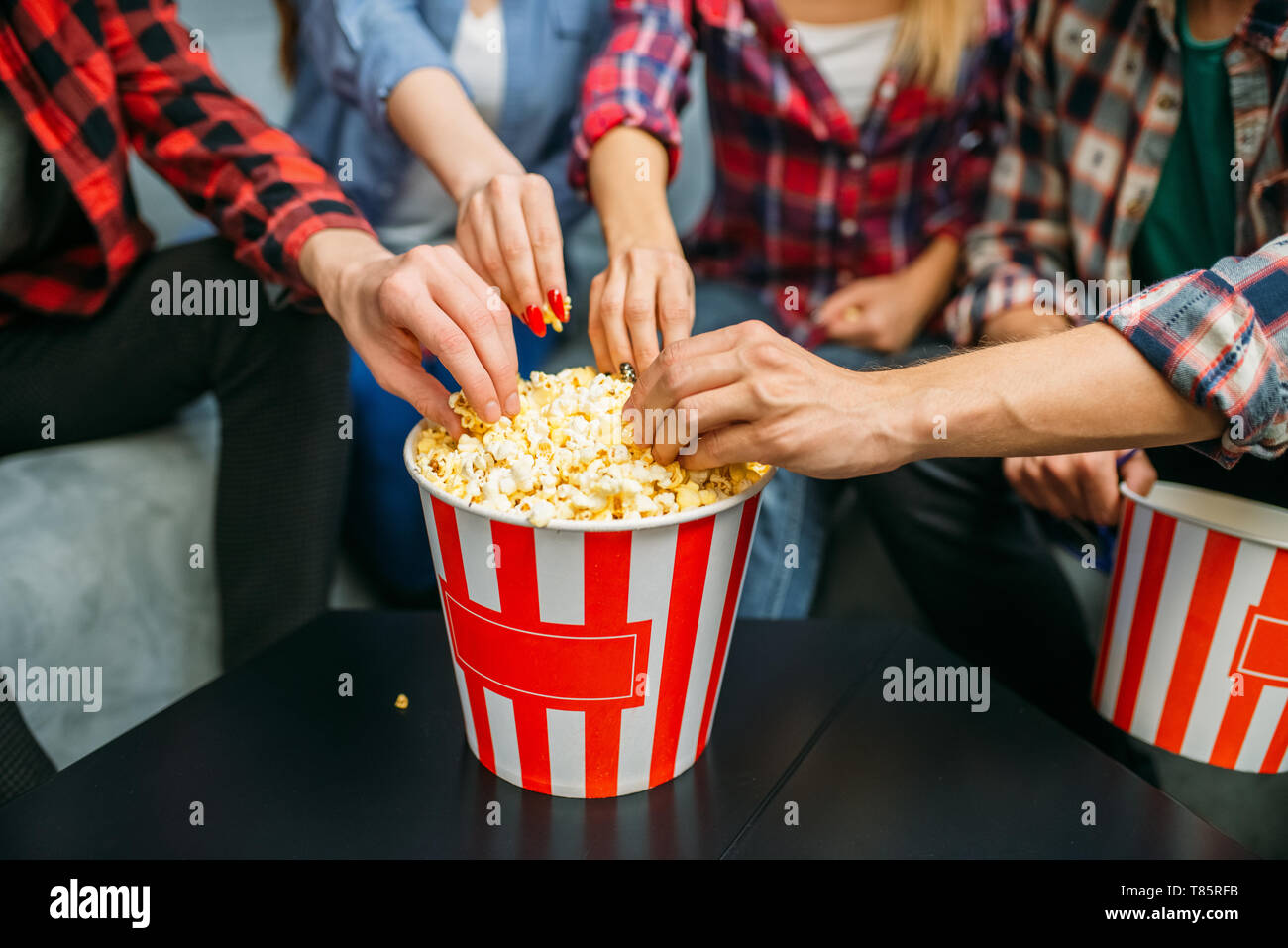 Group of people eating popcorn in cinema Stock Photo Alamy