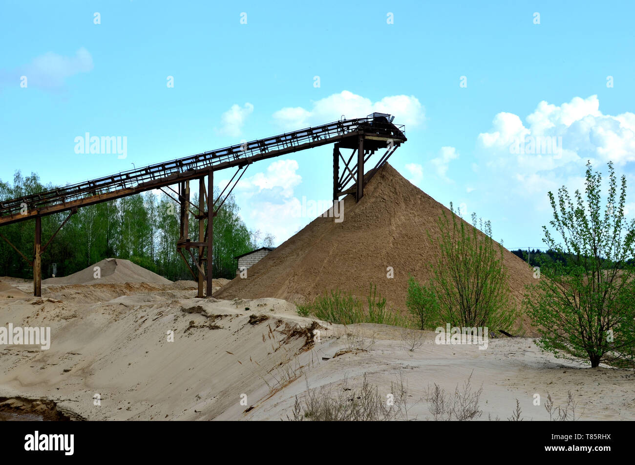 Sand Making Plant in mining quarry. Crushing factory, machines and equipment for crushing, grinding stone, sorting sand and bulk materials. Stock Photo