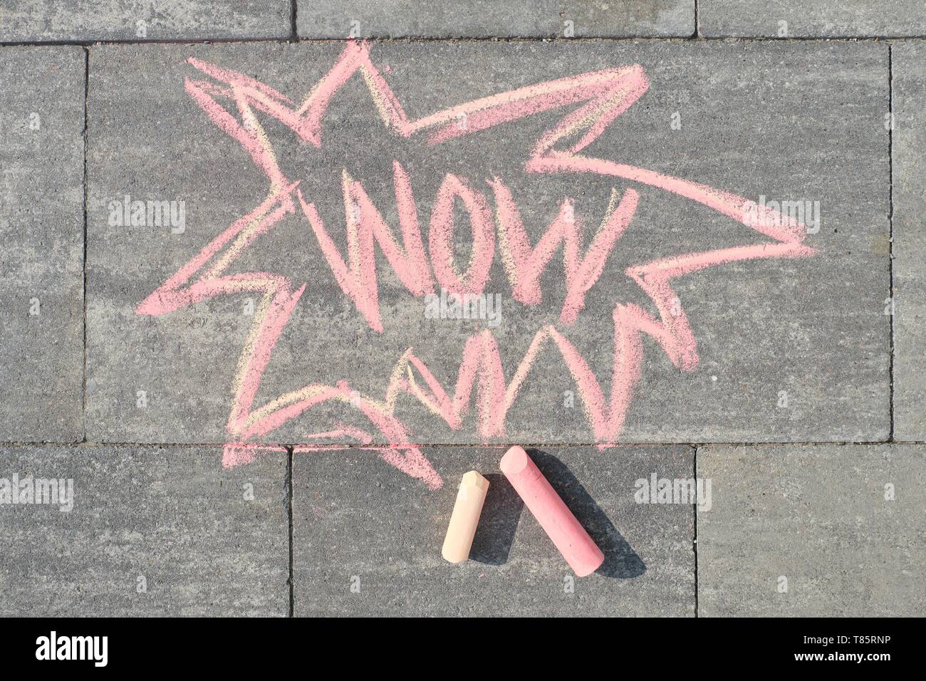 Wow written on gray sidewalk, top view. Stock Photo