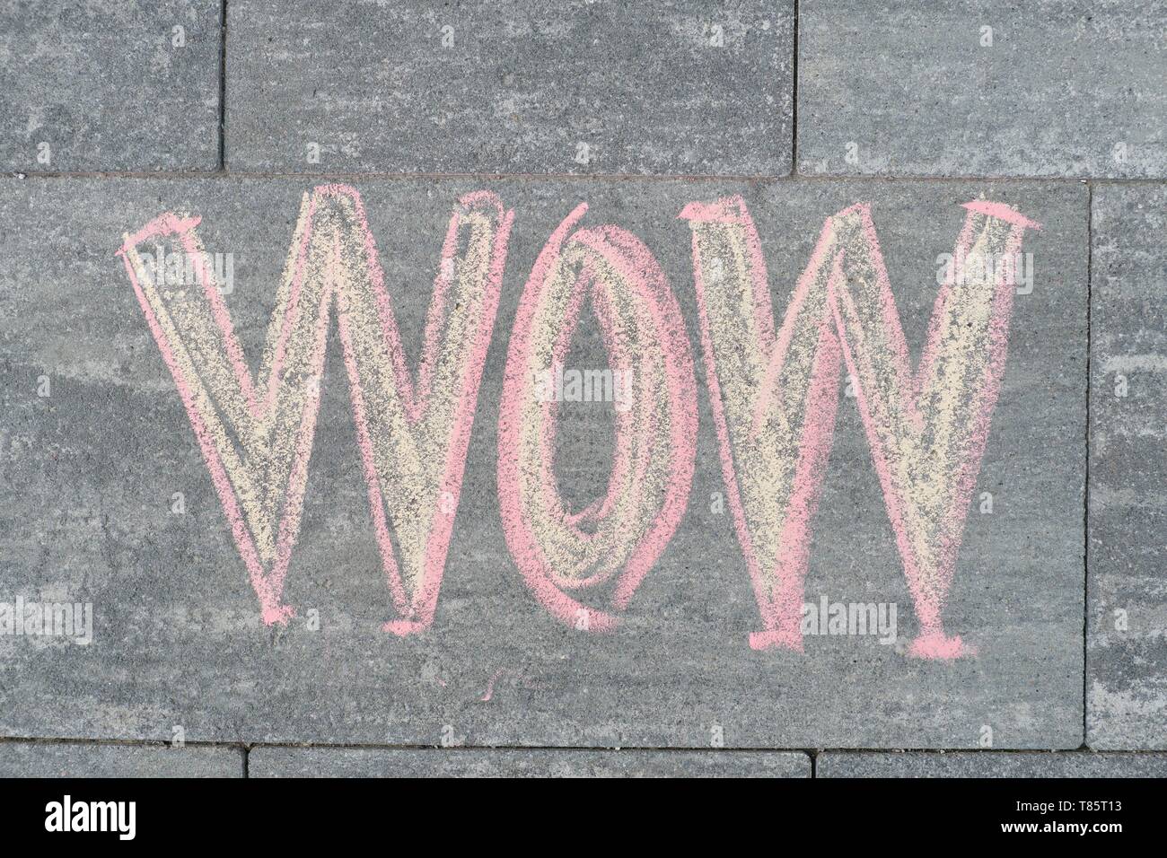 Wow written on gray sidewalk, top view. Stock Photo