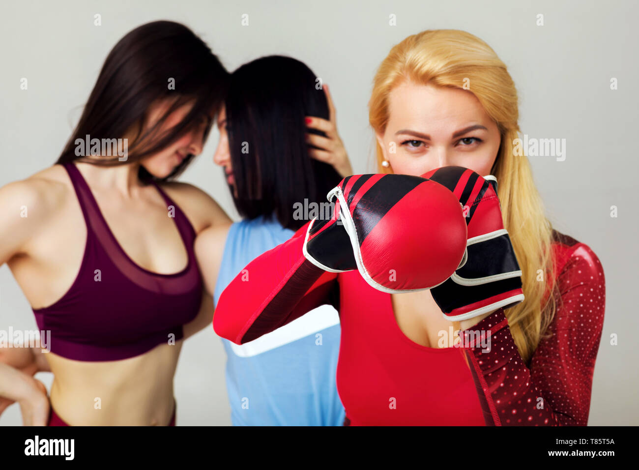 Portrait of confident young woman wearing red boxing gloves and black  sports bra Stock Photo - Alamy