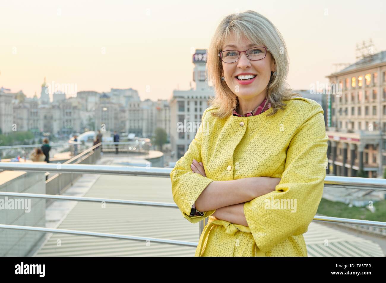 glasses, yellow raincoat. Woman 