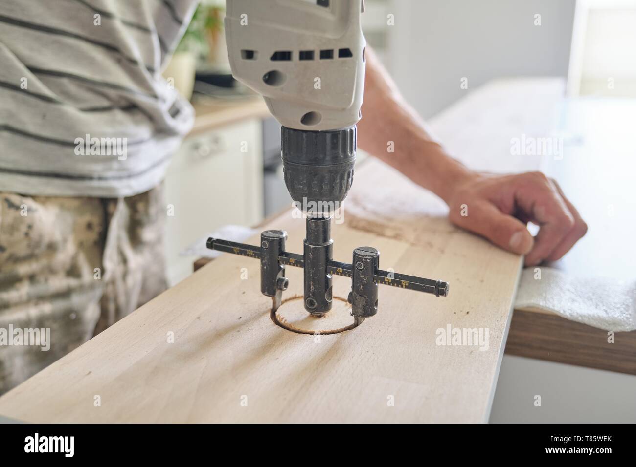 Close-up of carpenters hand using professional woodworking electric ...