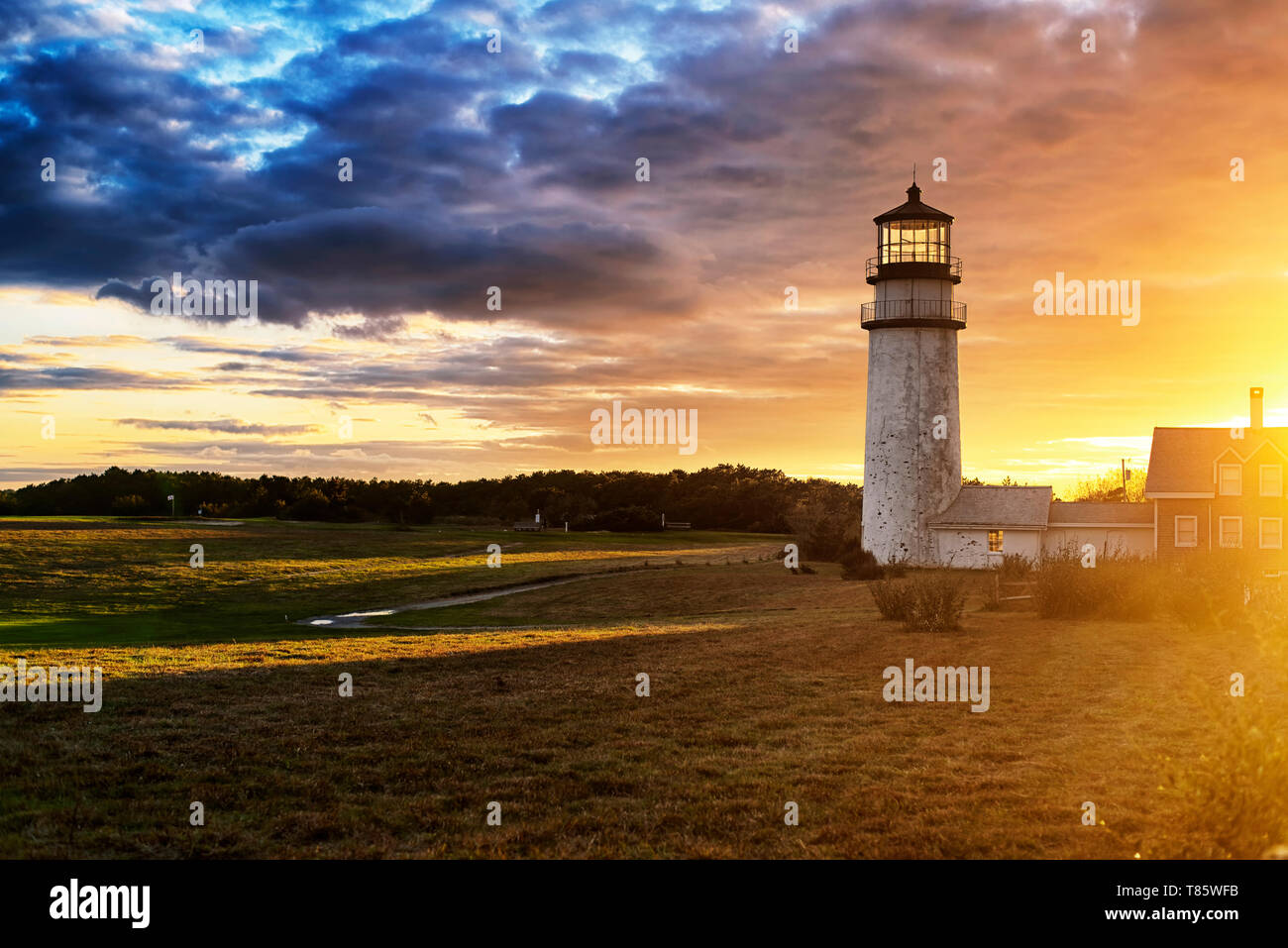 The Highland Lighthouse against a beautiful sunset in North Truro Massachusetts on the Cape Cod National Seashore. Stock Photo