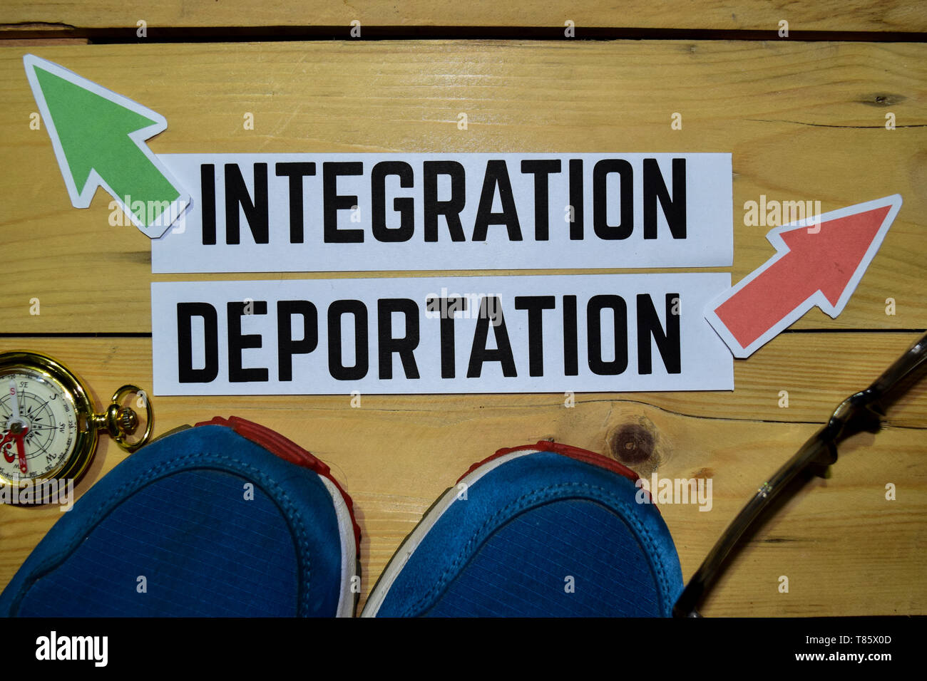Integration or Deportation opposite direction signs with sneakers