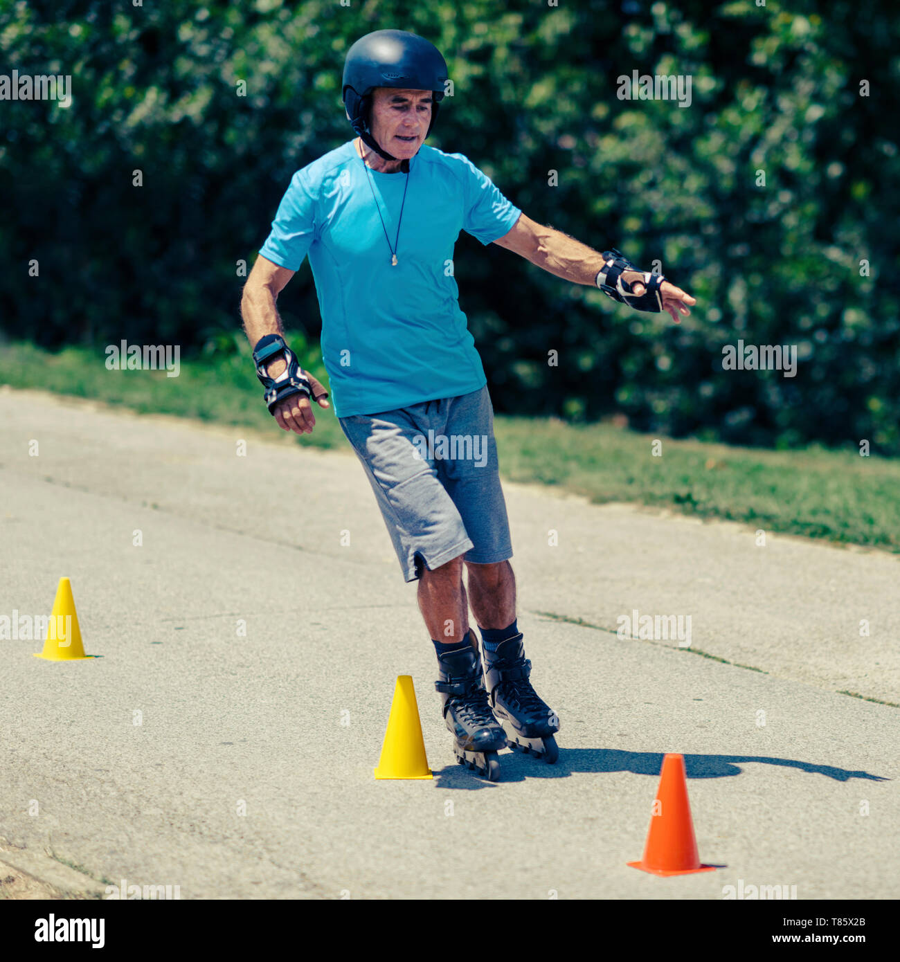 Senior man roller skating in park Stock Photo