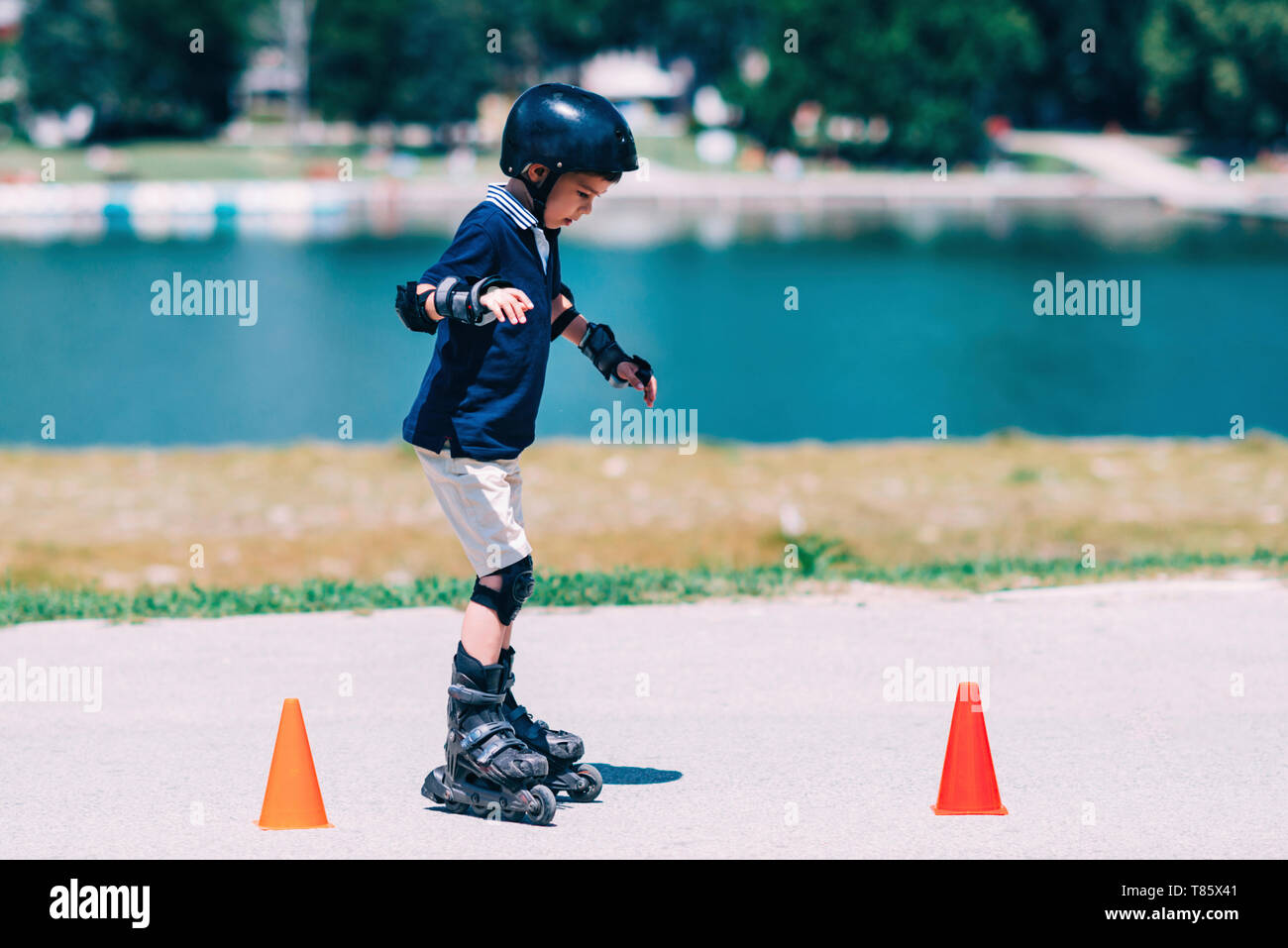 Boy learning to roller skate Stock Photo Alamy