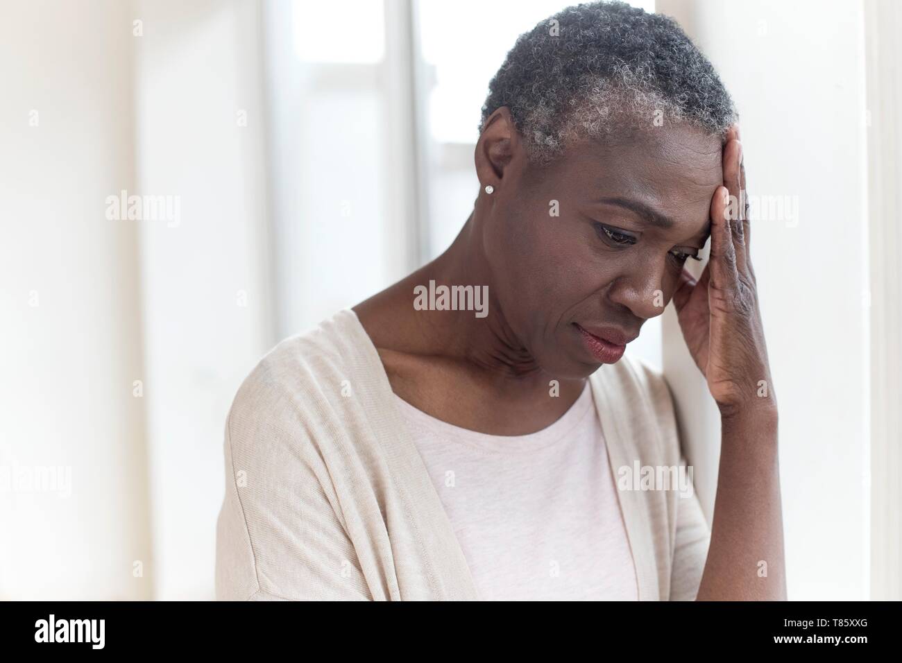 Woman touching head Stock Photo