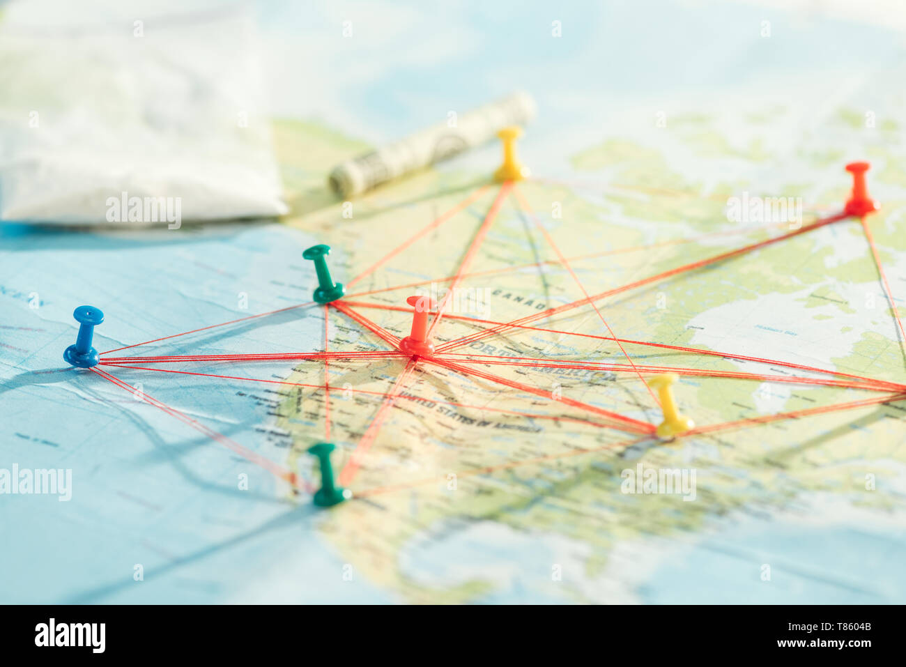 Selective focus of push pins and strings on world map Stock Photo - Alamy