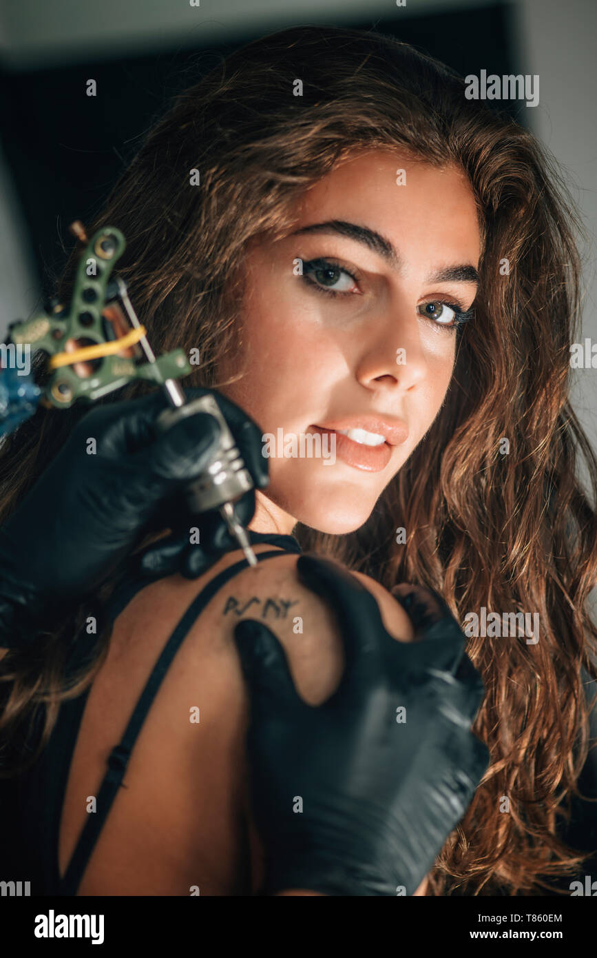 Woman getting a tattoo Stock Photo