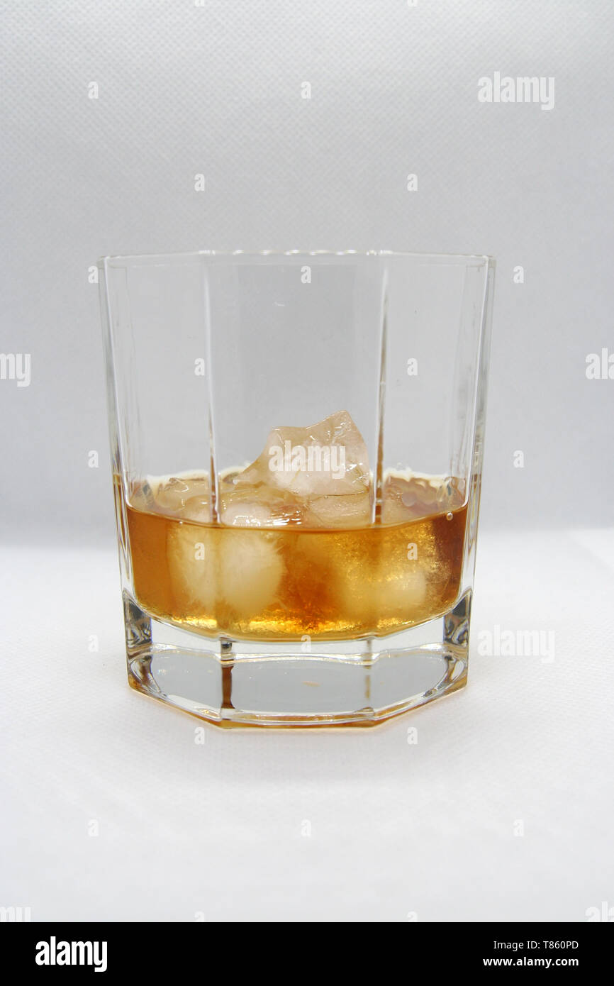 Whiskey on ice in a glass. Whiskey with ice cubes Stock Photo Alamy