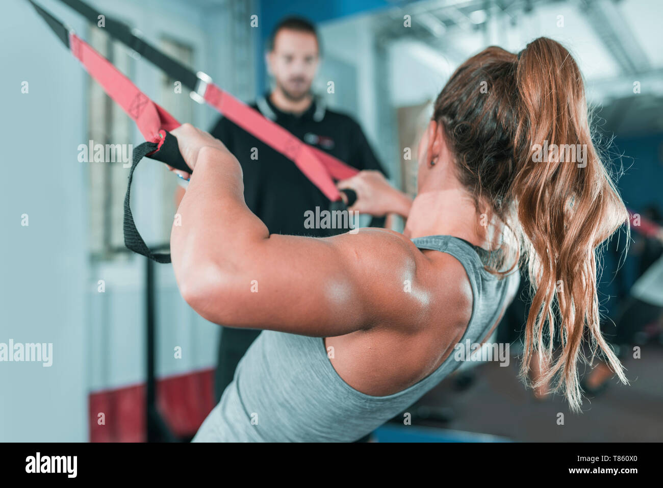 Woman doing TRX workout Stock Photo - Alamy