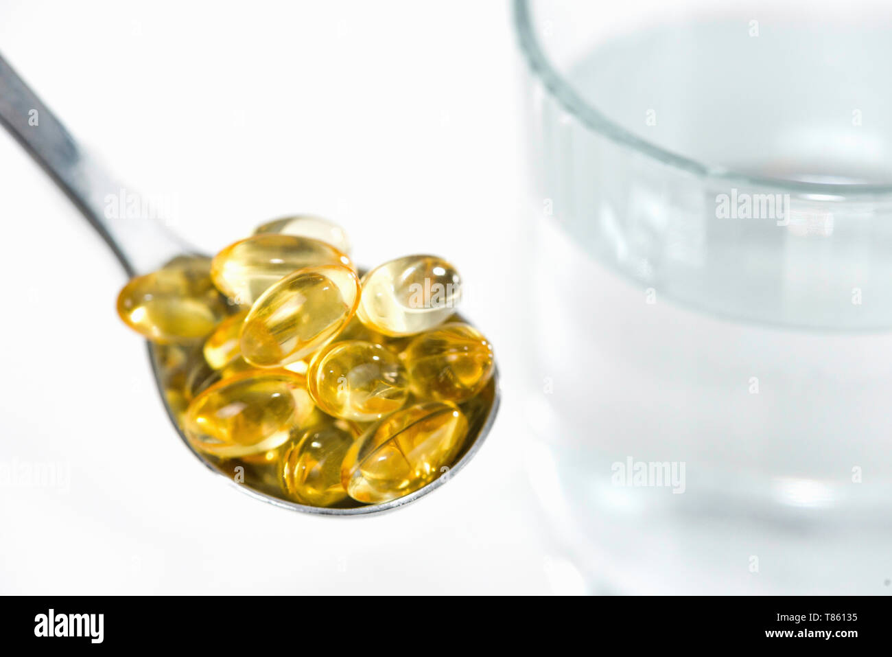 Vitamin E capsules and glass of water Stock Photo Alamy