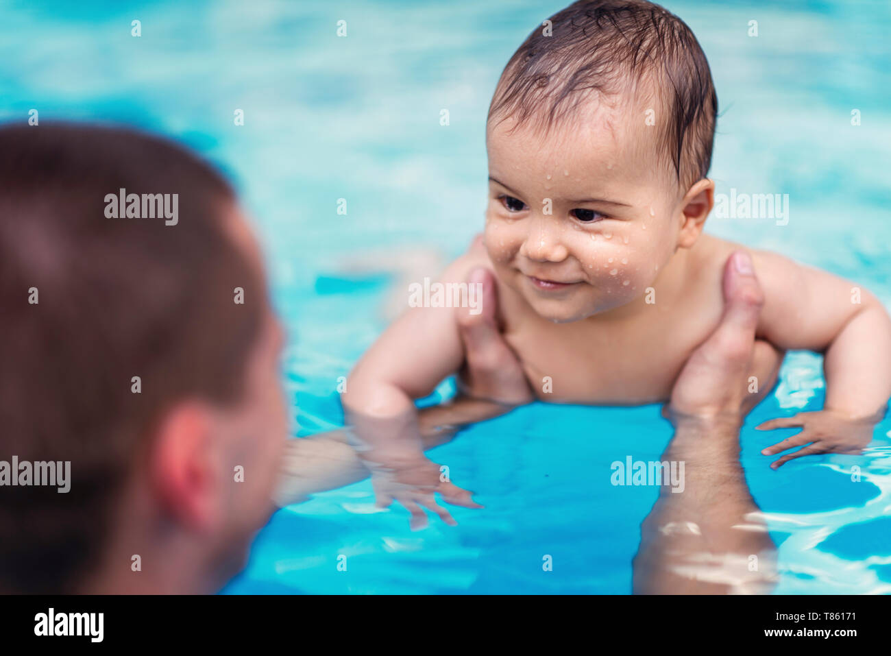 Baby smiling in swimming pool hires stock photography and images Alamy