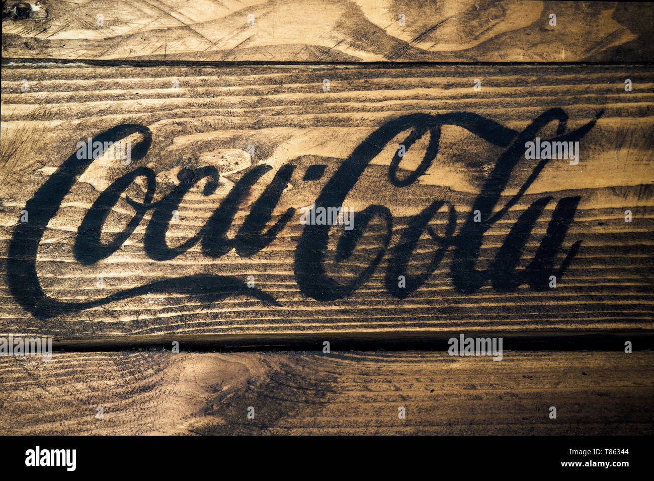Black Coca cola logo painted on rustic weathered wood Stock Photo