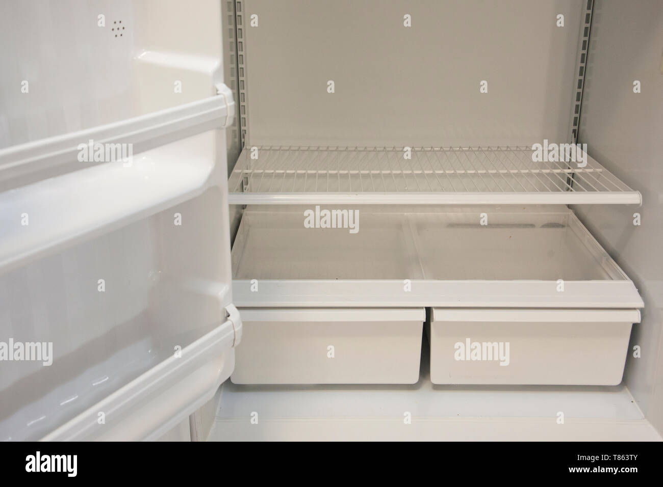 Bottom shelves and crisper in an empty refrigerator Stock Photo