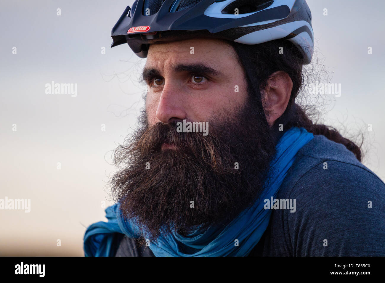 Young caucasian bearded man wearing a bike helmet Stock Photo
